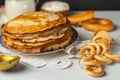 Pancakes on a plate, close-up. A stack of pancakes, on a linen napkin, bagels and a wooden spoon. Selective Focus