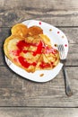 Pancakes on a plate in the form of hearts