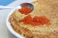 Pancakes on a plate with red caviar and spoon Royalty Free Stock Photo