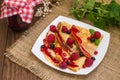 Pancakes with raspberries, currants, sugar and mint. Wooden background. Top view. Close-up