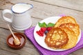 Pancakes with raspberry, blueberry, milk and honey syrup Royalty Free Stock Photo