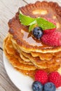 Pancakes with raspberry, blueberry, mint and honey syrup Royalty Free Stock Photo