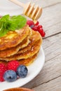 Pancakes with raspberry, blueberry, mint and honey syrup Royalty Free Stock Photo