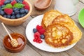 Pancakes with raspberry, blueberry, mint and honey syrup Royalty Free Stock Photo