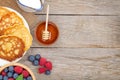 Pancakes with raspberry, blueberry, mint and honey syrup Royalty Free Stock Photo