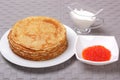 Pancakes, red caviar and sour cream Royalty Free Stock Photo