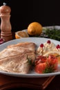 Pancakes with red fish, lemon and cranberries on a white plate, table served in restaurant in rustic style, concept of russian