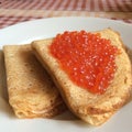 Pancakes with red salmon Caviar on plate for dating valentines day concept, traditional Russian cuisine Royalty Free Stock Photo