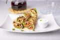 Pancakes with salmon (trout), sour cream, greenstuff and tea. Thin, not sweet blinchiki stuffed with red fish. Royalty Free Stock Photo