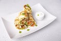 Pancakes with salmon (trout), sour cream and greenstuff. Thin, not sweet blinchiki stuffed with red fish. Royalty Free Stock Photo