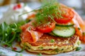 Pancakes with salted salmon, cucumber, greens and curd cheese