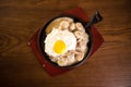 Pancakes with sausage and scrambled eggs in a frying pan. View above