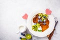 Pancakes in the shape of heart with berries, fruits and curd cream in a white plate, top view. Valentine`s day concept Royalty Free Stock Photo