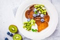 Pancakes in the shape of heart with berries, fruits and curd cream in a white plate, top view. Valentine`s day concept Royalty Free Stock Photo