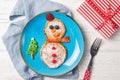 Pancakes in the shape of snowman, Christmas breakfast for kids idea, top view Royalty Free Stock Photo