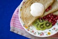 Pancakes with sour cream, kiwi fruit and pomgranate