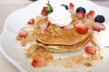 Pancakes sprinkled with strawberries and blueberries Royalty Free Stock Photo