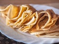 Pancakes stacked rolled konvetiki on a white plate close-up