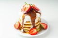 Pancakes stacked with strawberries, topped with  chocolate sauce and yoghurt Royalty Free Stock Photo
