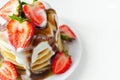 Pancakes stacked with strawberries, topped with  chocolate sauce and yoghurt Royalty Free Stock Photo