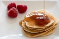 Pancakes stake with golden syrup and strawberries