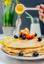 Pancakes with strawberry, bluberry and honey