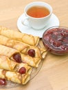 Pancakes with strawberry jam and a cup of tea. top view Royalty Free Stock Photo