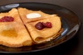 Pancakes with strawberry jam, raspberry jam , sour cream and honey Royalty Free Stock Photo