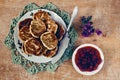Pancakes with strawberry jam on a wooden background