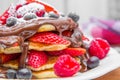 Dish with pancakes and strawberry,raspberry and blueberry and chocolate