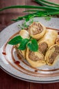 Pancakes stuffed with liver. Wooden rustic background. Top view