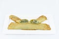 3 pancakes stuffed with spinach and cheese served on a white plate on a white background Royalty Free Stock Photo
