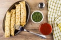 Pancakes with stuffing in dish, fork, dill, pepper and juice Royalty Free Stock Photo