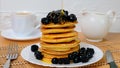 Pancakes. Sweet honey pouring over pancakes with berry fruit. Tasty breakfast food