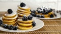 Pancakes. Sweet honey pouring over pancakes with berry fruit. Tasty breakfast food