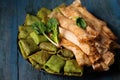 Pancakes with sweet and salty filling on a plate, decorated with spinach leaves Royalty Free Stock Photo