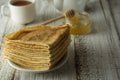 Pancakes. Thin pancakes. Russian bliny. Healthy tasty breakfast - pancakes, a cup of tea and honey. Copy space Royalty Free Stock Photo