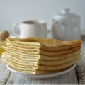 Pancakes. Thin pancakes. Russian bliny. Healthy tasty breakfast - pancakes, a cup of tea and honey. Square iamge