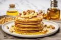 pancakes topped with golden pats of butter and nuts