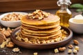 pancakes topped with golden pats of butter and nuts