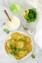 Pancakes from zucchini, served with sour cream or yogurt and various herbs. Useful vegetarian food.