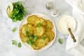 Pancakes from zucchini, served with sour cream or yogurt and various herbs. Useful vegetarian food.