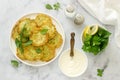 Pancakes from zucchini, served with sour cream or yogurt and various herbs. Useful vegetarian food.