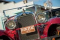 Pancevo, Serbia - September 27, 2019: Front side of red vintage 1928 Pontiac car parked in collectors museum courtyard