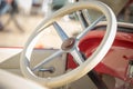 Pancevo, Serbia - September 27, 2019: Steering wheel of red vintage 1928 Pontiac car parked in collectors museum courtyard
