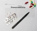 Pancreatitis diagnosis written on a white piece of paper