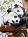 Panda bear graffiti on a wall.