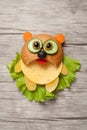 Panda created from bread, cheese and vegetables on wooden background