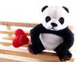 Panda doll on the handmade wooden chair, feeling fall in love concept