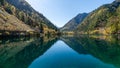 Panda Lake\'s water reflection in Jiuzhaigou, China: A mirror to the sky and autumn trees Royalty Free Stock Photo